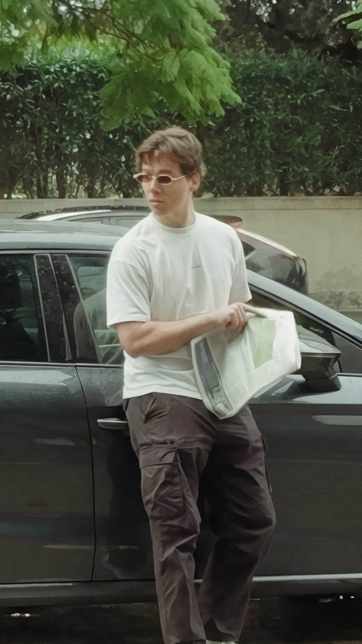 Le Lemud streetwear lookbook video featuring model wearing white oversized t-shirt on a city street