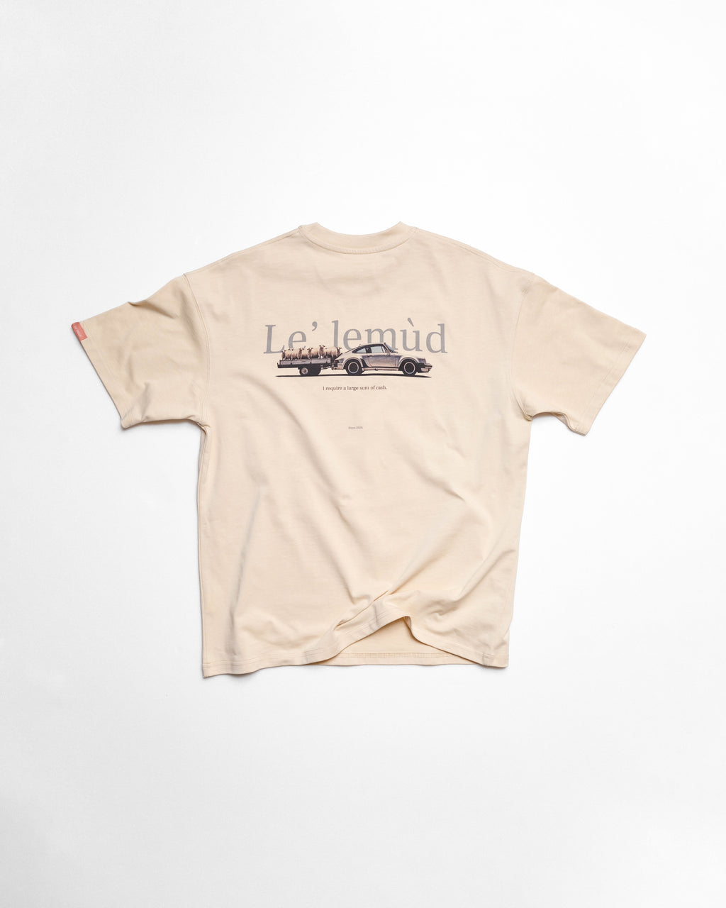 Flatlay of Lelemud Economist tee in cream showing back print with vintage car graphic