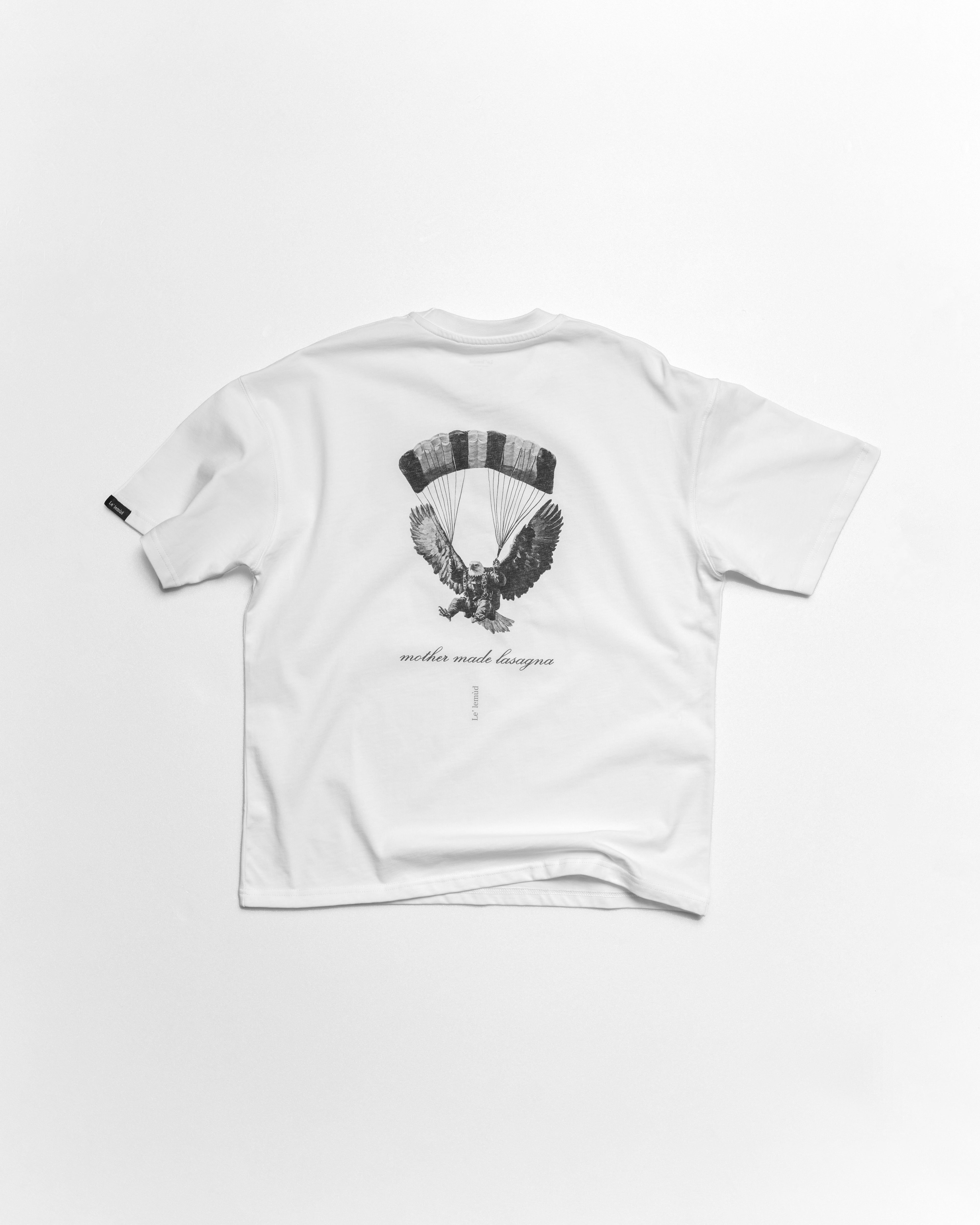 White oversized t-shirt with premium black eagle design on a white background by le lemud luxury streetwear