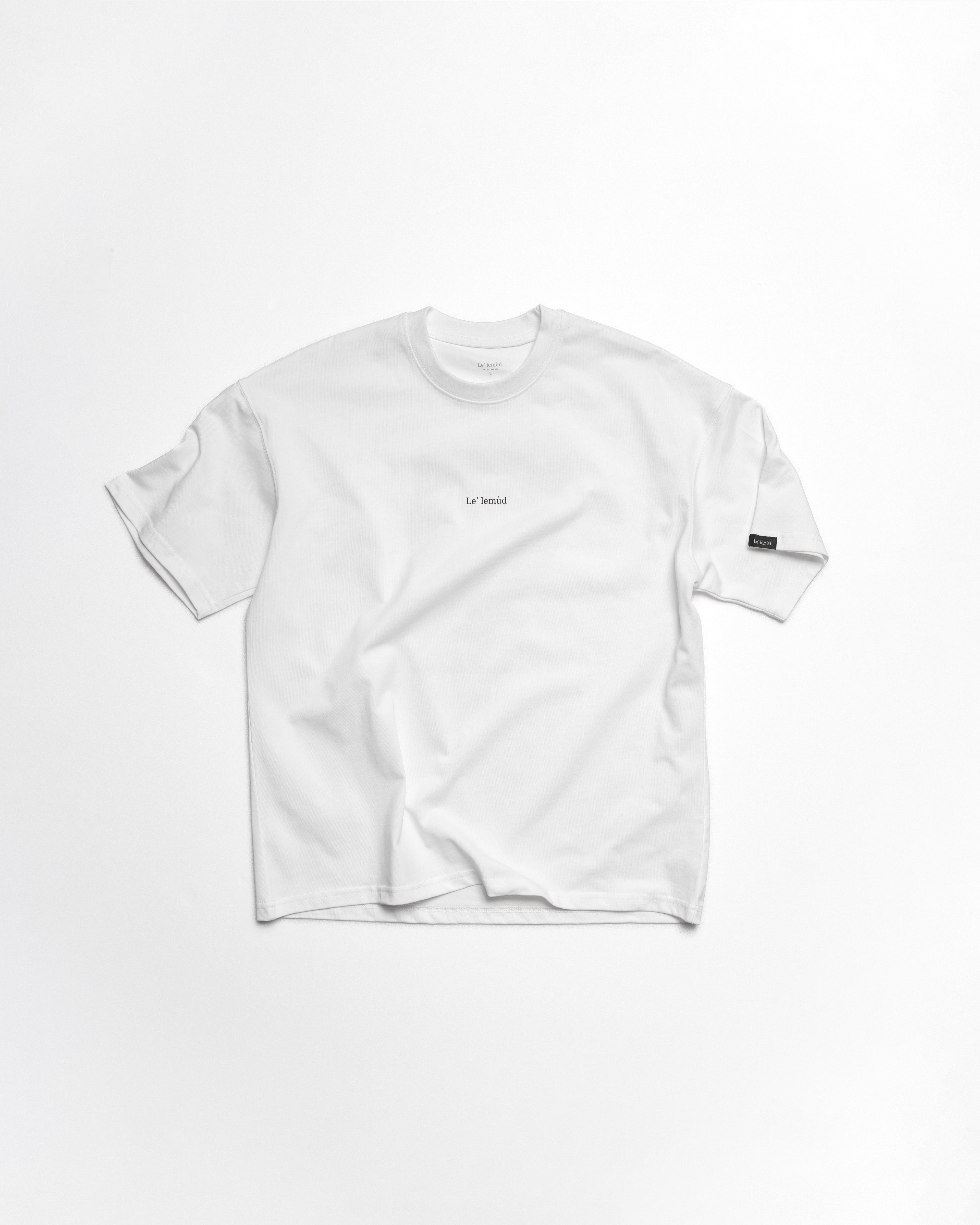 White oversized t-shirt with Le Lemud logo on the chest and woven sleeve label, front view on white background